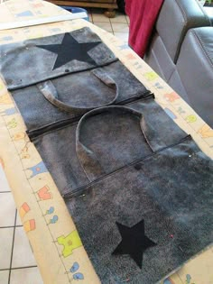 a piece of cloth with black stars on it sitting on top of a table next to a couch