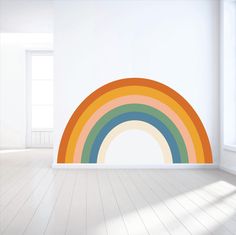 an empty room with a rainbow painted on the wall