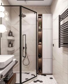 a bathroom with a walk in shower next to a white sink and black and white tiled floor