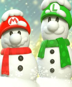 two snowmen wearing hats and scarves standing next to each other in the snow