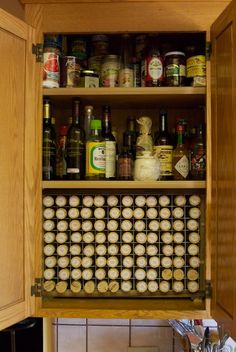 an open cabinet filled with lots of bottles