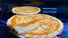 two pies sitting on top of a glass table