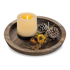 a candle sitting on top of a wooden tray