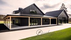 a large black house sitting on top of a lush green field