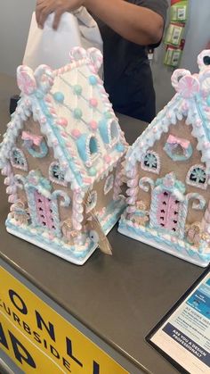 two gingerbread houses are on display at a store