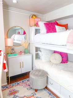 a bedroom with bunk beds and white furniture