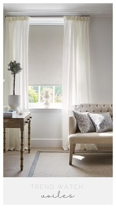 a living room with white curtains and a couch in front of a window that says trend watch