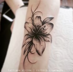 a black and white flower tattoo on the leg