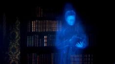 a person standing in front of a bookshelf with blue light coming from it