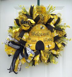 Bee hive Wreath For Front Door, Summer Wreath, Bee Door hanger, Wedding Gift, Summer decor, Housewarming gift, Grapevine wreath. This wreath is made on a wreath frame with 2 deco mesh, bow, 5 ribbon, flowers and a metal welcome to our hive sign. Measures approximately 24" x 24" x 6" Bee Hive Wreath, Bee Door Hanger, Welcome To Our Hive, Hanger Wedding, Bee Wreath, Wreath Frame, Sunflower Wreath, Bee Decor, Sunflower Wreaths