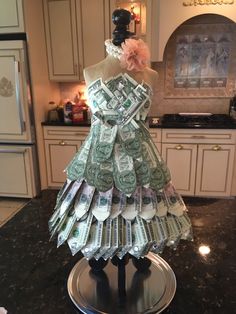 a dress made out of money sitting on top of a counter