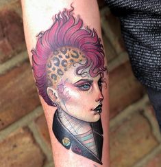 a woman with pink hair and leopard print on her arm