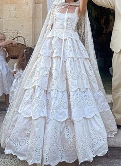 a woman in a white wedding dress standing next to a man