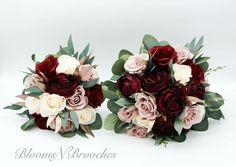 two bridal bouquets with red, pink and white flowers on them sitting side by side