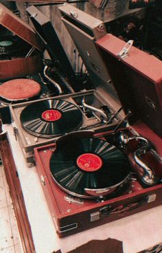 an assortment of turntables and suitcases on display