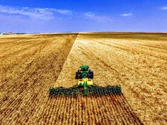 an aerial view of a tractor in a field