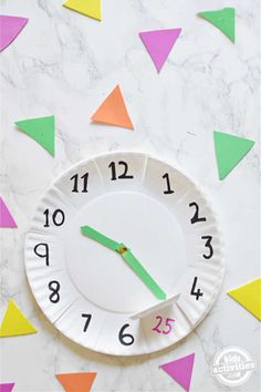 a paper plate with a clock on it