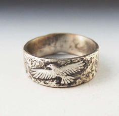 Here is a photoshopped image of what the hawk ring will approximately look like . It's sterling overlayed with fine silver. The patina brings out the lovely painterly quality. These are custom made to your size and take about 2 weeks. Since I make each one by hand, no two are exactly alike. I can also work with you to create a design of your own. Contact me so we can discuss your ideas further. If you are unsure of your size, you can purchase this ring sizer. It is adjustable, tells you the size Nature-inspired Carved Sterling Silver Jewelry, Silver Bird Ring, Jewelry Mood Board, Bird Ring, Bird Rings, Silver Bird, Syracuse Ny, Animal Rings, Dope Jewelry