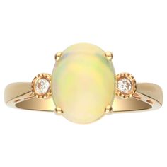 an opal and diamond ring in yellow gold