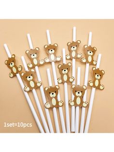 there are many brown teddy bears on white sticks