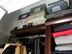 an organized closet with clothes and other items