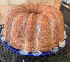 a bundt cake sitting on top of a blue plate next to an oven rack