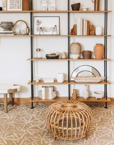 the shelves in this room are filled with vases and other decorative items on them