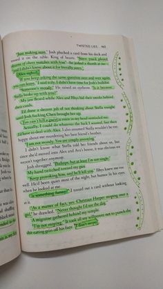 an open book with green writing on it