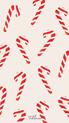 candy canes in red and white on a light blue background with the word holiday written below them