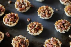 many pecan pies are arranged on a baking sheet