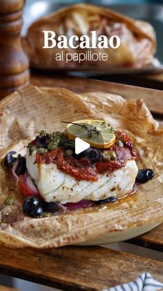 a plate with some food on it and the words bacalao at papillote