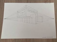 a drawing of a house on top of a wooden table