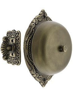 an antique style door handle with ornate design on the front and back side of it