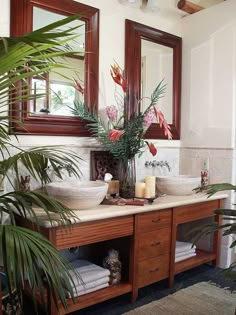 a bathroom with two sinks and plants in it