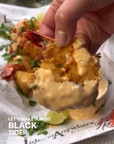 a person is dipping some kind of food in it's wrapper with sauce