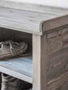 a shoe is sitting on top of a wooden shelf