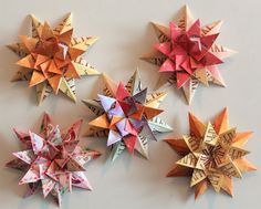 four origami stars are arranged on the wall, each with their own name