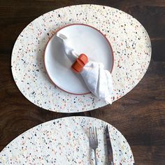 two plates with napkins and forks on them