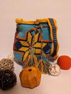 Colorful Handmade Colombian Medium Mochila Made in crochet by Colombian Wayuu indigenous. Perfect as a gift on any occasion. Approximate Size: Length: 10.25, width: 9.20, and cord: 54 Inches. Hand wash cold, do not tumble dry. Made in Colombia. Artisan Woven Bag As Gift, Artisan Woven Bag As A Gift, Rectangular Crochet Bag With Adjustable Strap As Gift, Gift Crochet Shoulder Bag With Adjustable Strap, Yellow Artisan Bags For Daily Use, Crochet Shoulder Bag With Adjustable Strap As Gift, Multicolor Woven Bucket Bag As Gift, Multicolor Woven Bucket Bag Gift, Bohemian Multicolor Bags For Gifts