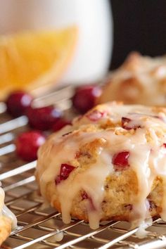 cranberry orange scones with icing on a cooling rack