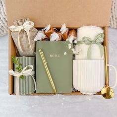 a box filled with lots of different items next to a gold spoon and some napkins