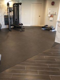 home gym flooring installed over wood look vinyl tile Basement Tile, Tile Over Tile, Garage Flooring Options, Exercise Rooms, Basement Conversion, Gym Floor Mat, Home Gym Flooring, Floor Exercise, Interlocking Foam Tiles