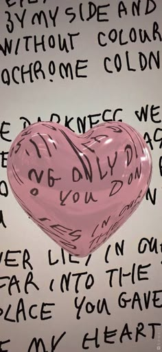 a pink heart with words written all over it and on the wall behind it is a piece of paper that says, i love you