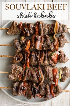 skewered meat and vegetables on a white plate with text overlay that reads souvlaki beef shish kebabs