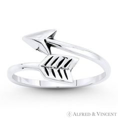 The featured ring is cast in oxidized .925 sterling silver and showcases a bypass ring style made from a finely crafted looped arrow design. Your purchase will include a 30-Day Exchange or Money-Back Guarantee & Free US Shipping. Please email us for more details regarding this listing. Size: 5.  Color: Metal Type.  Gender: female.  Age Group: adult. Silver Pearl Ring, Arrow Ring, Masonic Ring, Art Deco Diamond Rings, Silver Toe Rings, Bypass Ring, Right Hand Rings, Arrow Design, Diamond Cocktail Rings