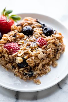 a close up of a plate of food with granola and fruit on it that says easy baked oatmeal