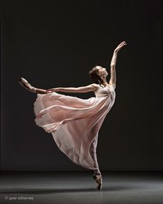 a woman in a white dress is dancing