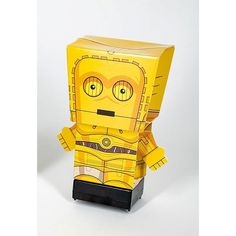 a yellow paper toy that looks like a robot