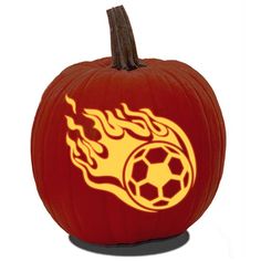 a pumpkin with flames and a soccer ball on it