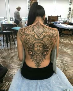 a woman with a tattoo on her back